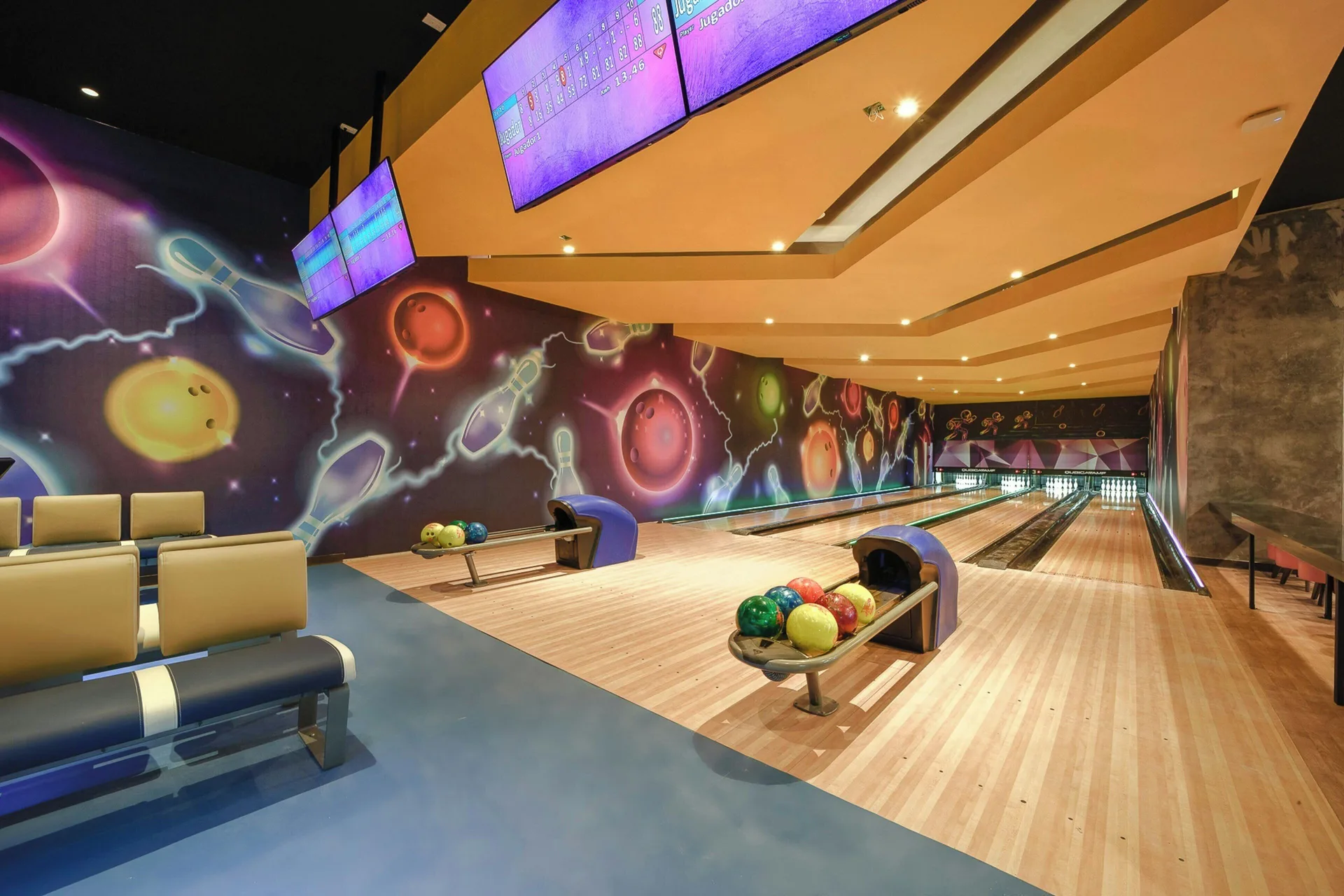 Bowling lanes with colorful wall art at Royalton Splash Riviera Cancun.