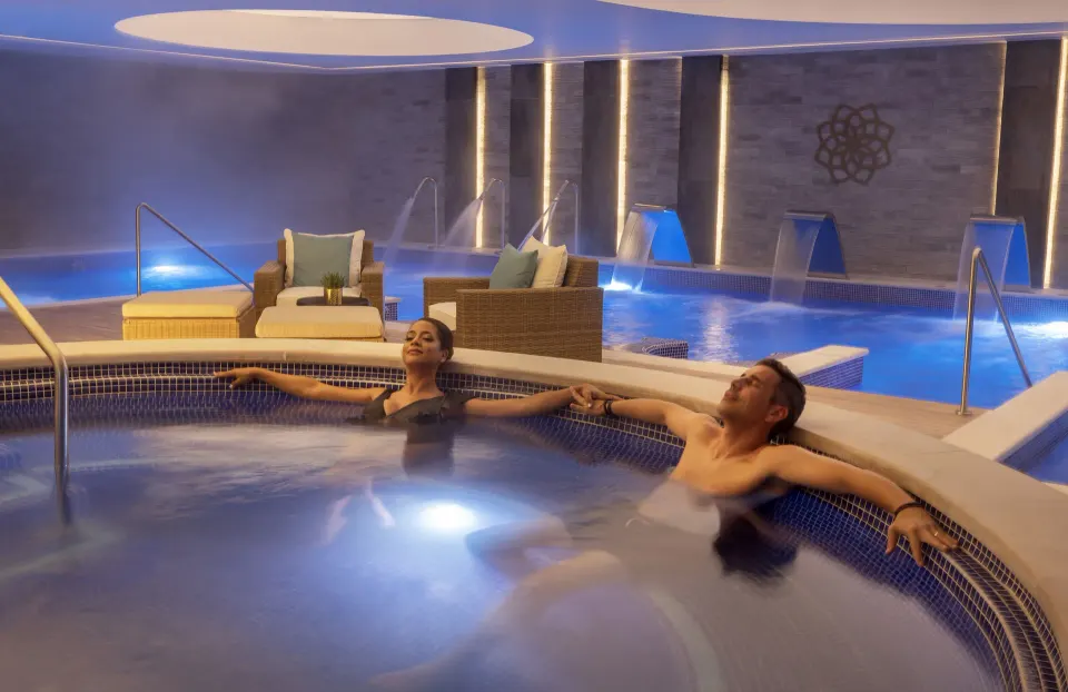 Couple reclining in an indoor spa pool at Royalton Splash Riviera Cancun.