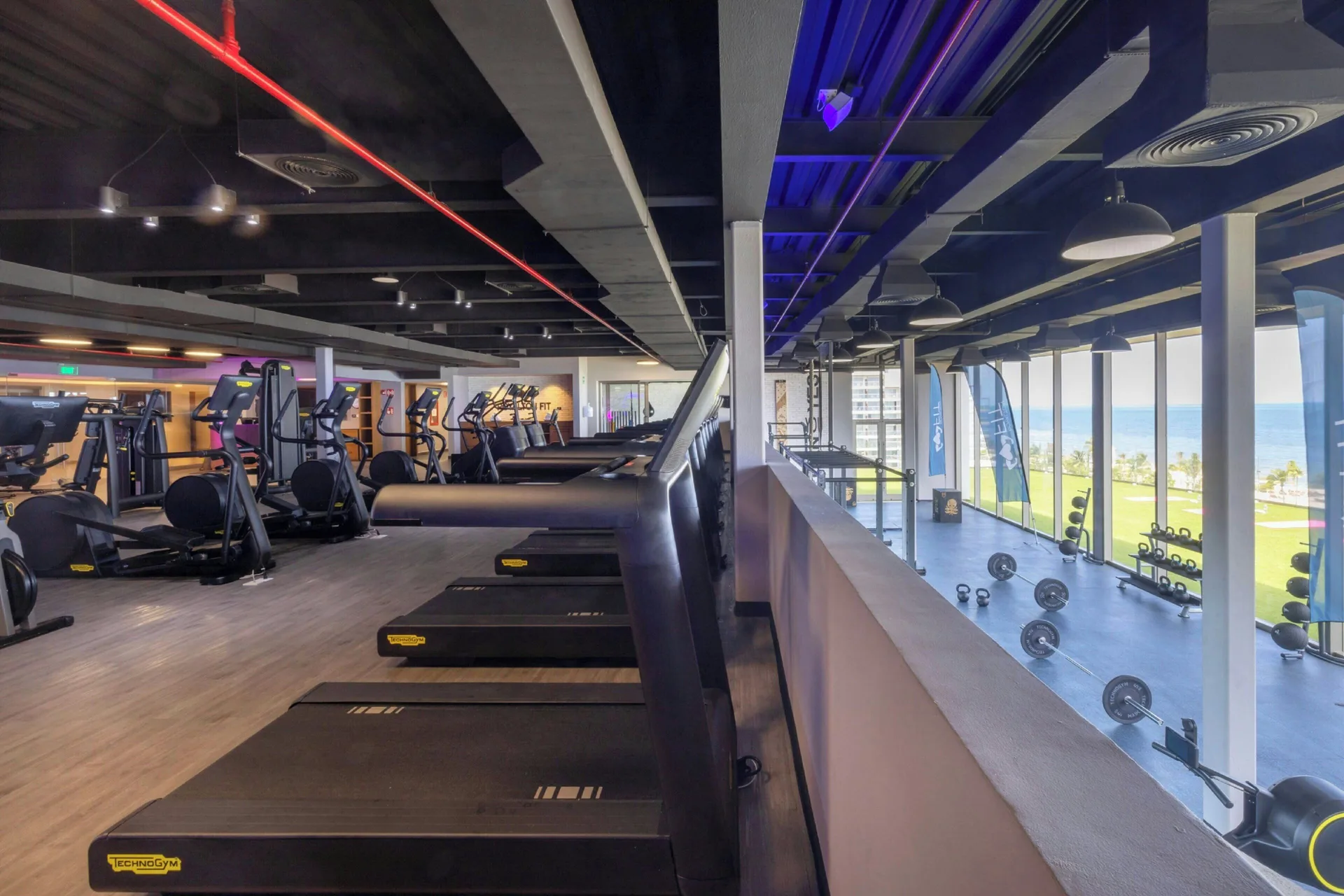 Fitness center with treadmills and ocean-facing windows at Royalton Splash Riviera Cancun.
