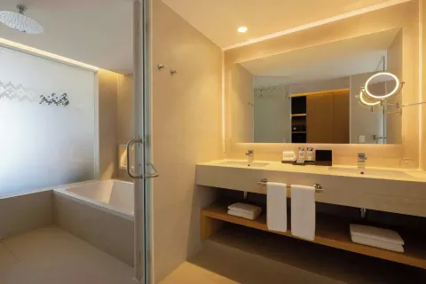 Bathroom with double vanity, shower, and tub at Royalton Splash Riviera Cancun.