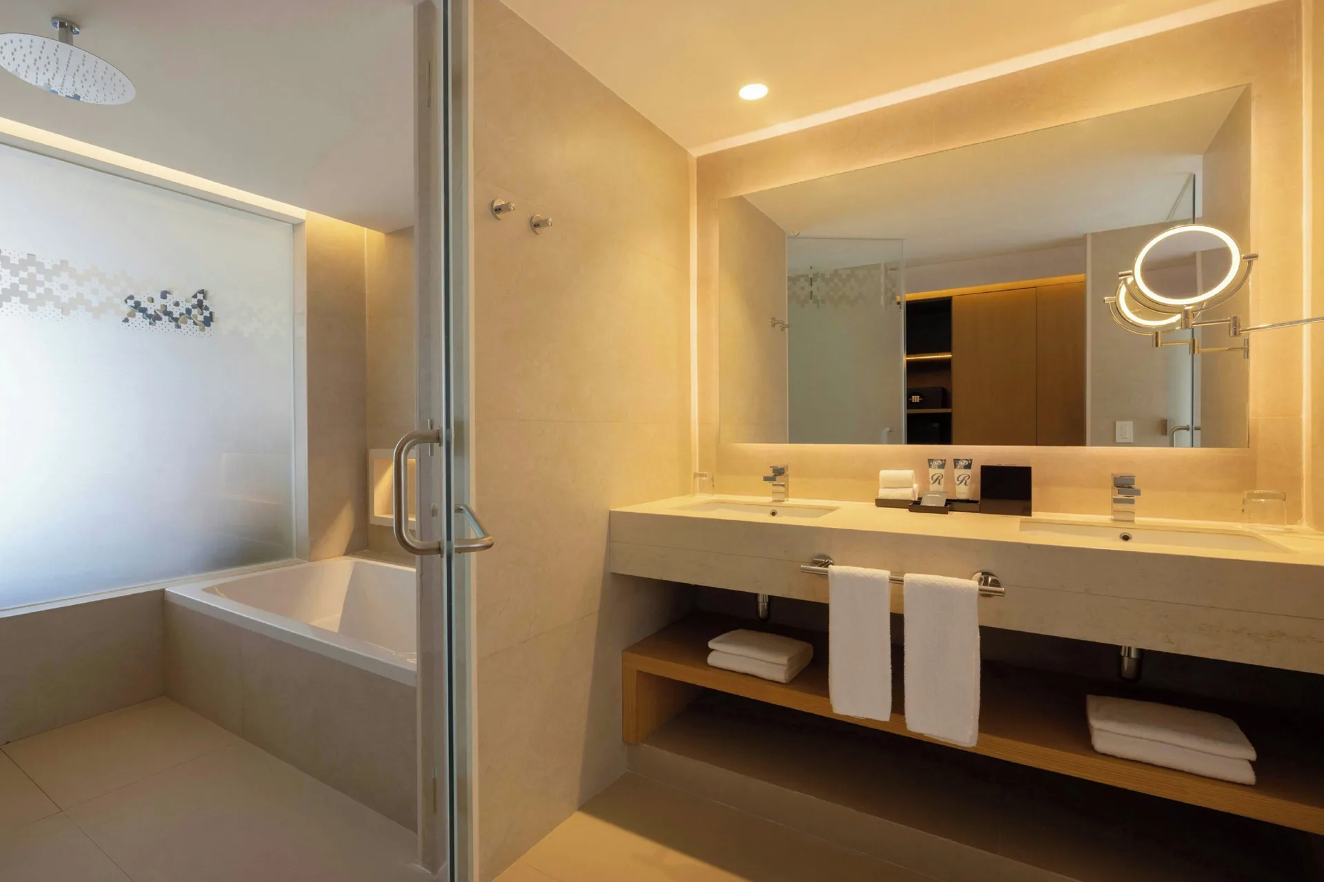 Bathroom with double vanity, shower, and tub at Royalton Splash Riviera Cancun.