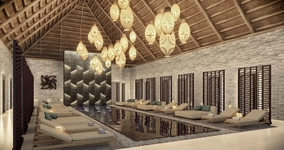 Indoor spa pool with loungers and pendant lights at Royalton Splash Riviera Cancun.
