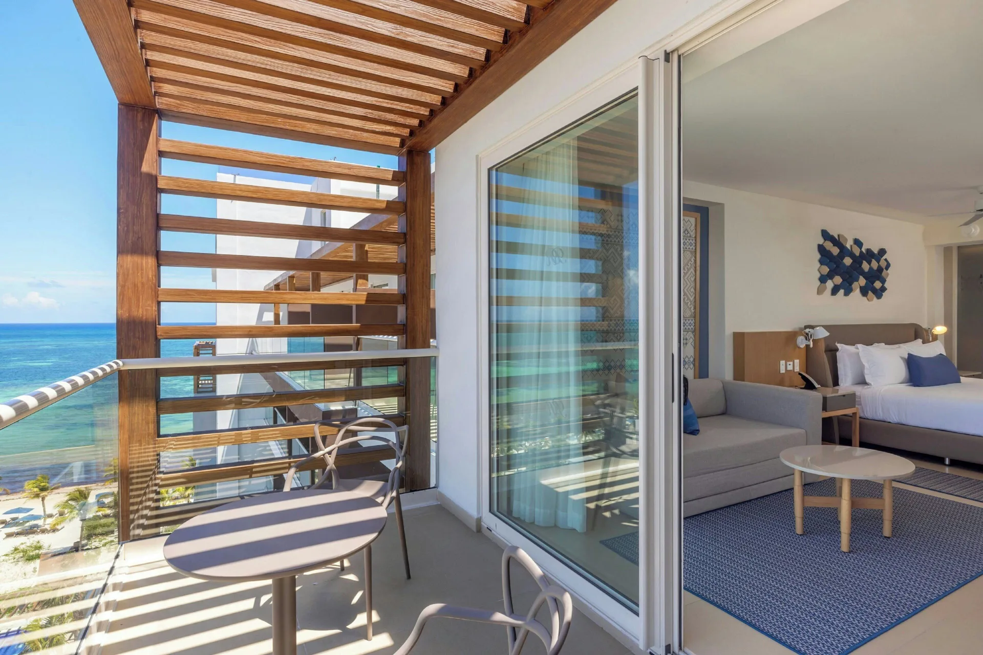 Balcony with ocean view beside a king-bed guest room at Royalton Splash Riviera Cancun.