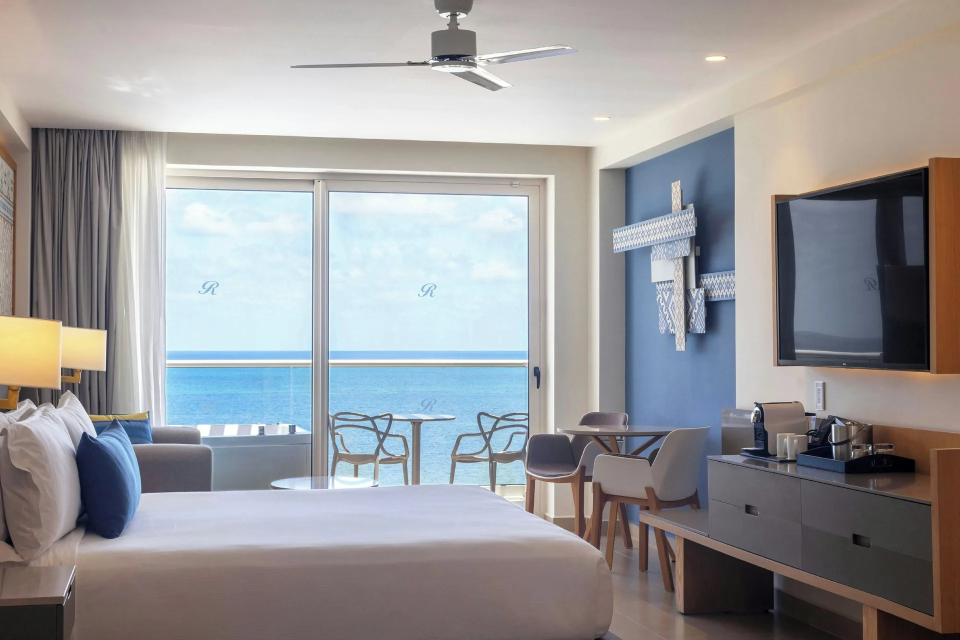 Ocean view guest room with king bed and balcony at Royalton Splash Riviera Cancun.