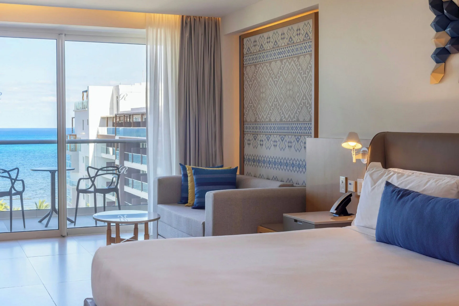 King guest room seating area with balcony and sea view at Royalton Splash Riviera Cancun.