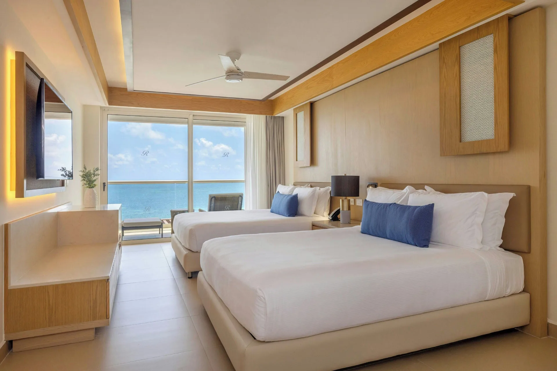 Ocean-view guest room with two queen beds at Royalton Splash Riviera Cancun.