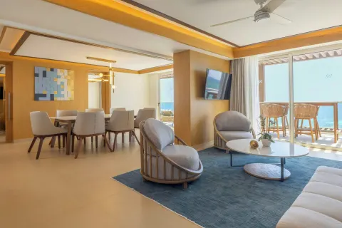 Oceanfront suite living and dining area with balcony at Royalton Splash Riviera Cancun.