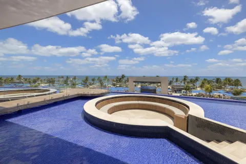 Rooftop infinity pool with circular seating and ocean view at Royalton Splash Riviera Cancun.