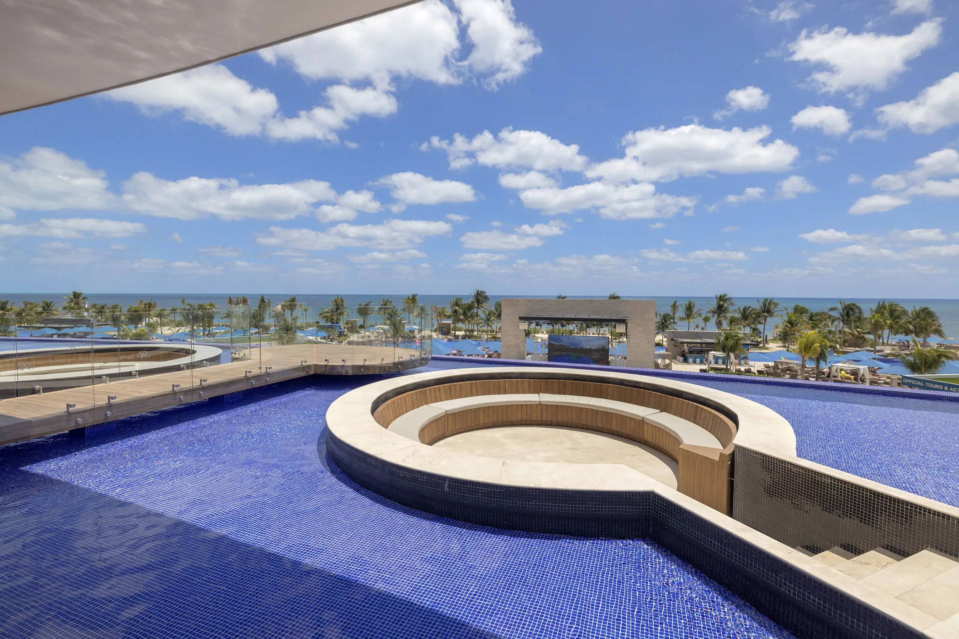 Rooftop infinity pool with circular seating and ocean view at Royalton Splash Riviera Cancun.