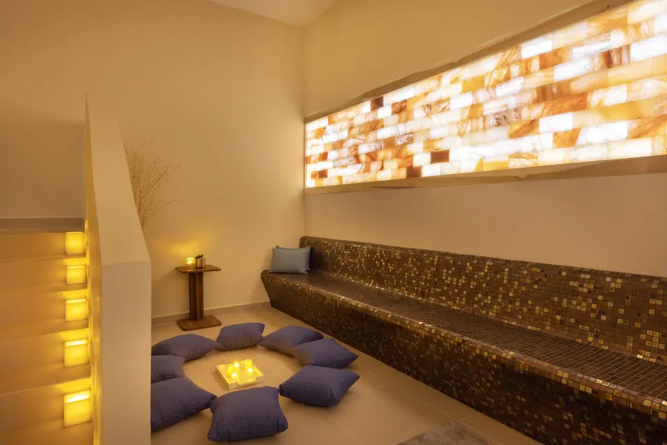Quiet spa lounge with mosaic bench and floor cushions at Royalton Splash Riviera Cancun.