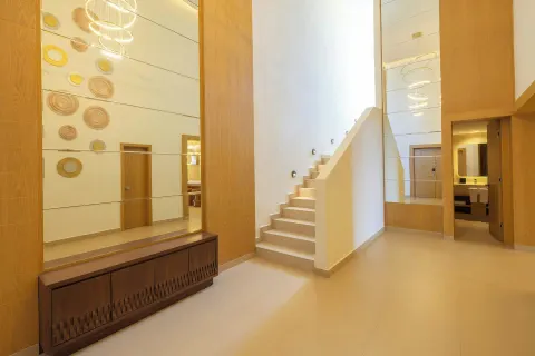 Tall suite foyer with staircase and mirrored wall at Royalton Splash Riviera Cancun.