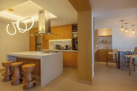 Suite kitchen and dining area with island seating at Royalton Splash Riviera Cancun.
