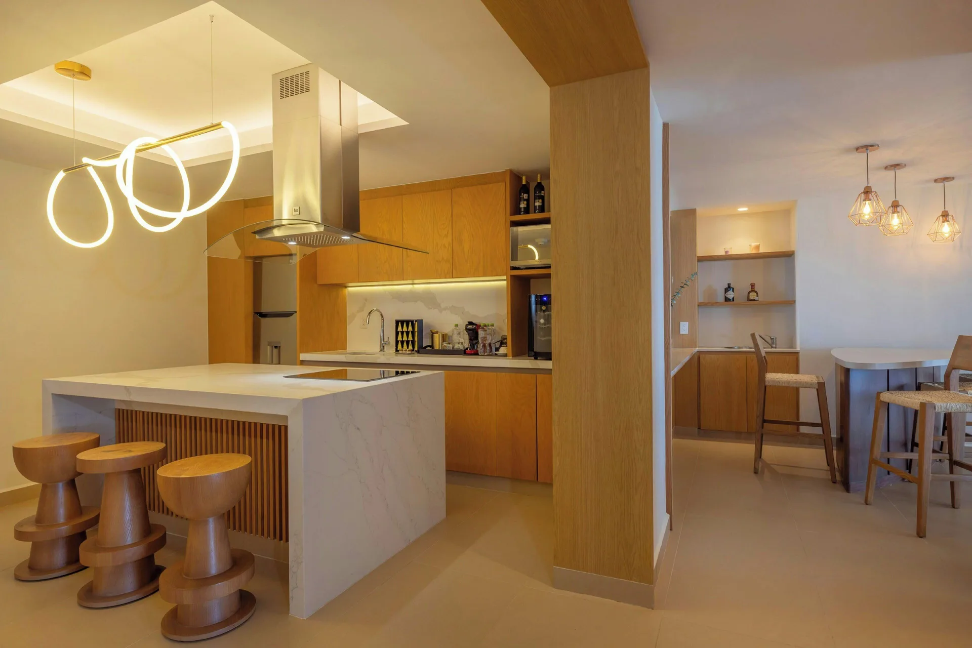 Suite kitchen and dining area with island seating at Royalton Splash Riviera Cancun.