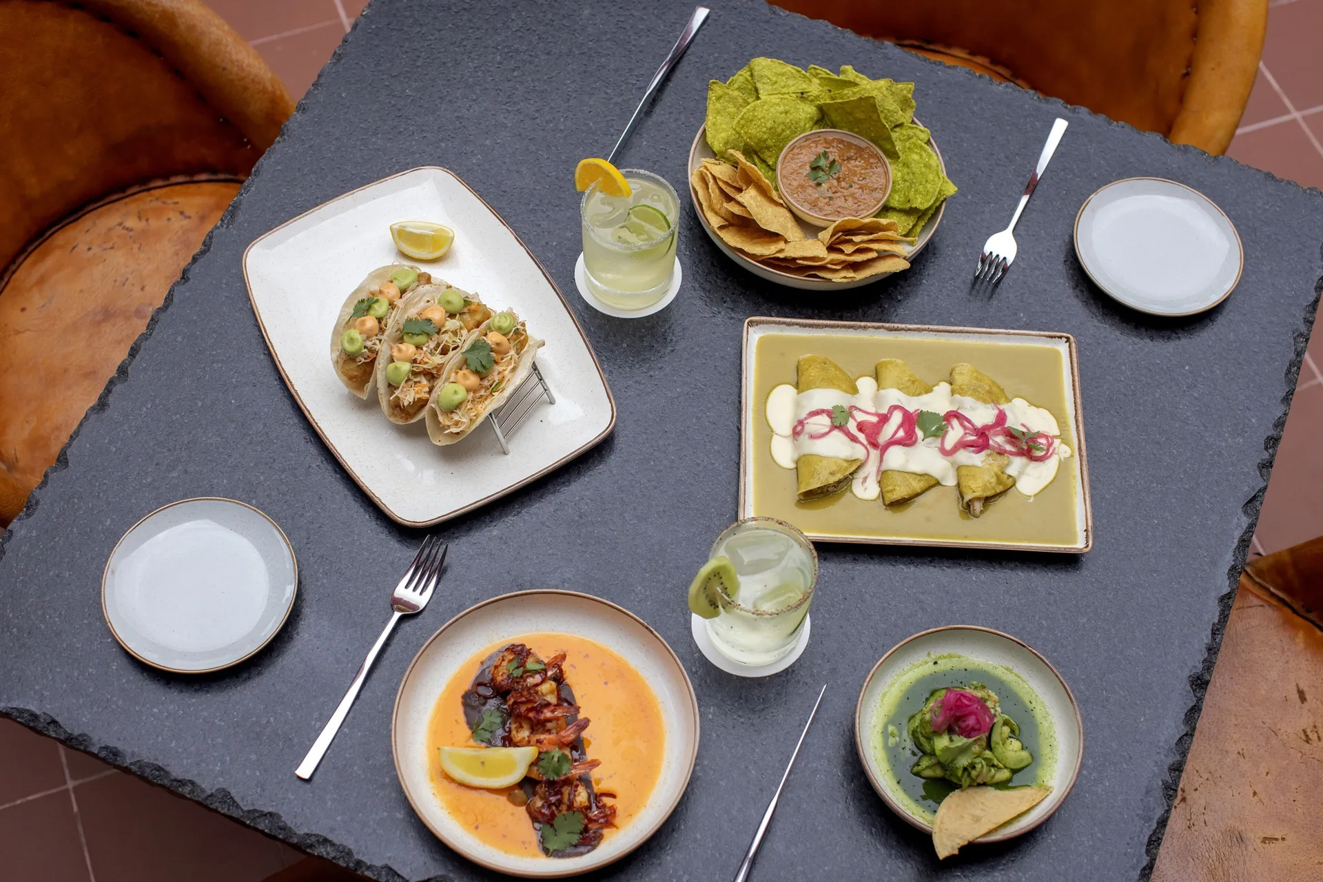 Mexican dishes, chips, dips and drinks on a table at Royalton Splash Riviera Cancun.