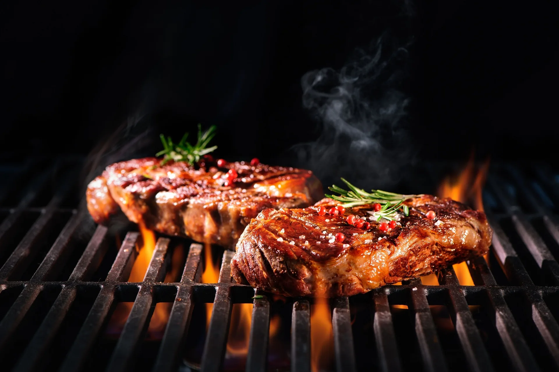 Steaks grilling over open flames at Royalton Splash Riviera Cancun.
