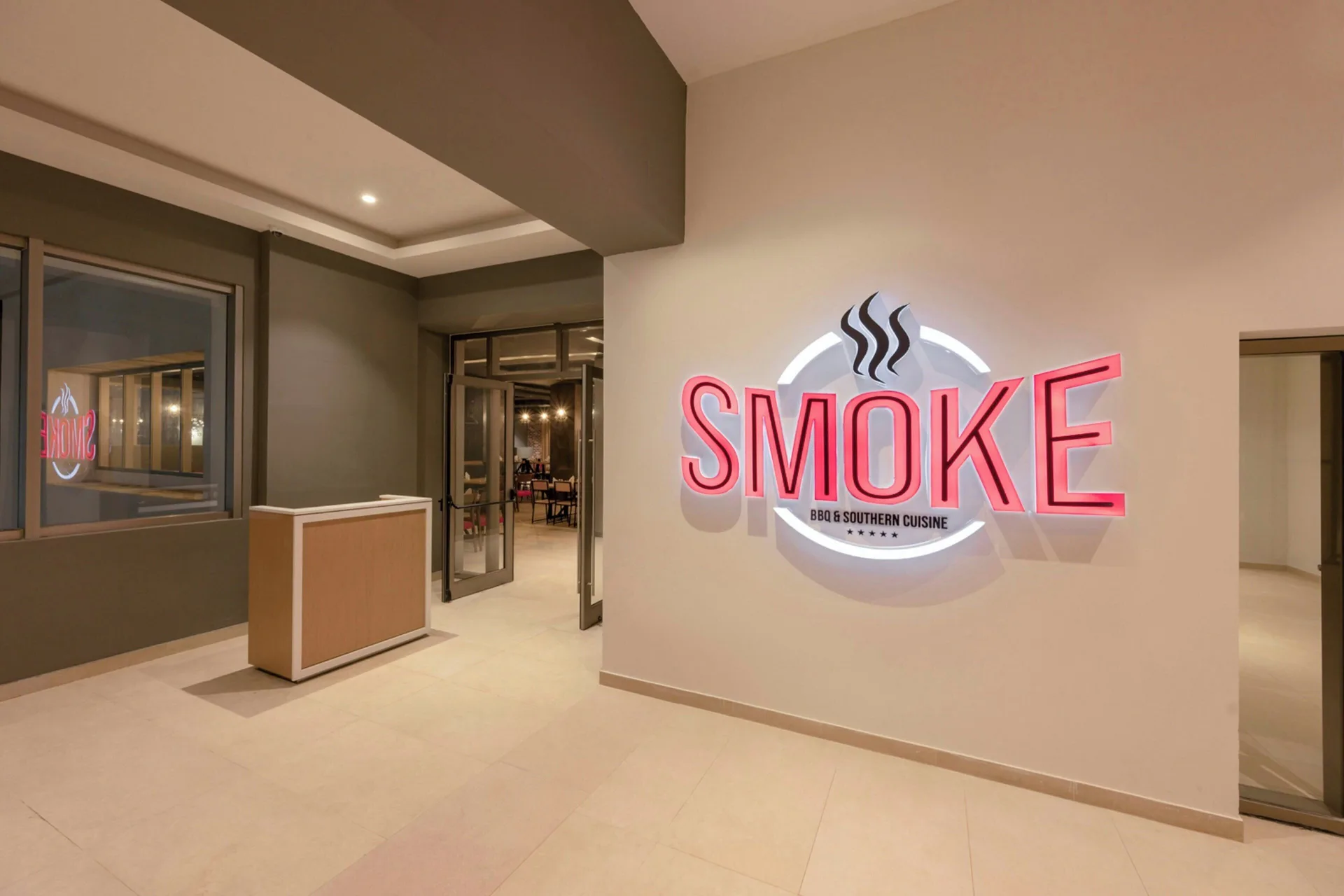 Smoke BBQ entrance sign in a corridor at Royalton Splash Riviera Cancun.