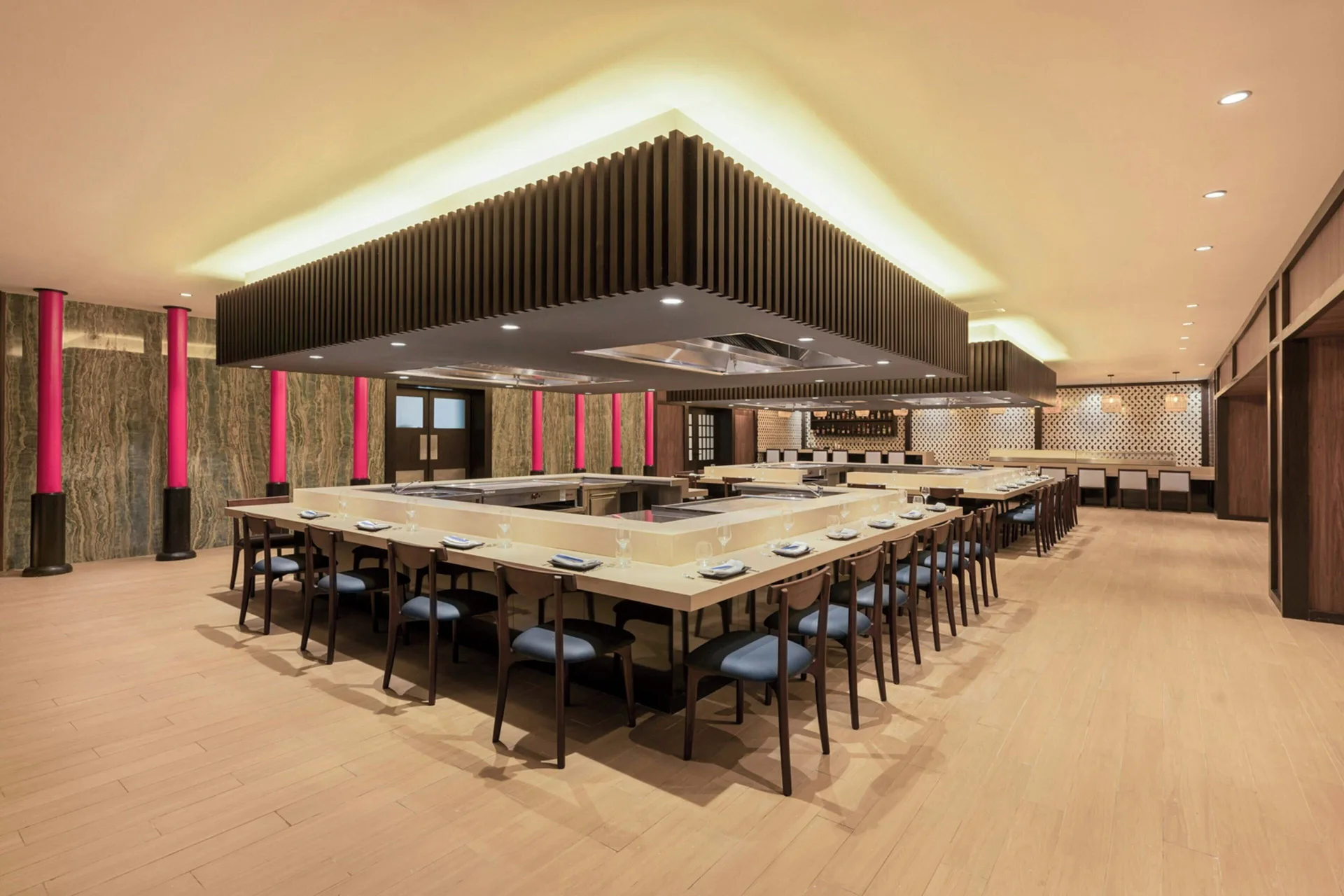 Large teppanyaki dining room at Royalton Splash Riviera Cancun with counters and rows of chairs.