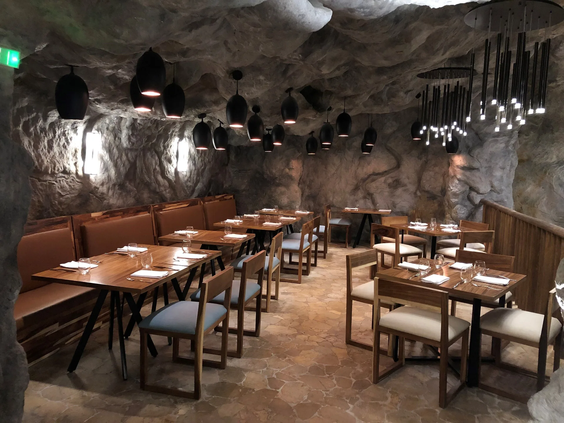 Cave-themed dining room with set tables at Royalton Splash Riviera Cancun.