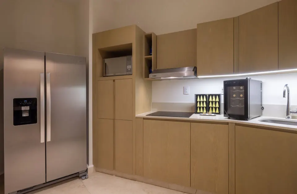 Suite kitchenette with refrigerator, microwave and sink at Royalton Splash Riviera Cancun.