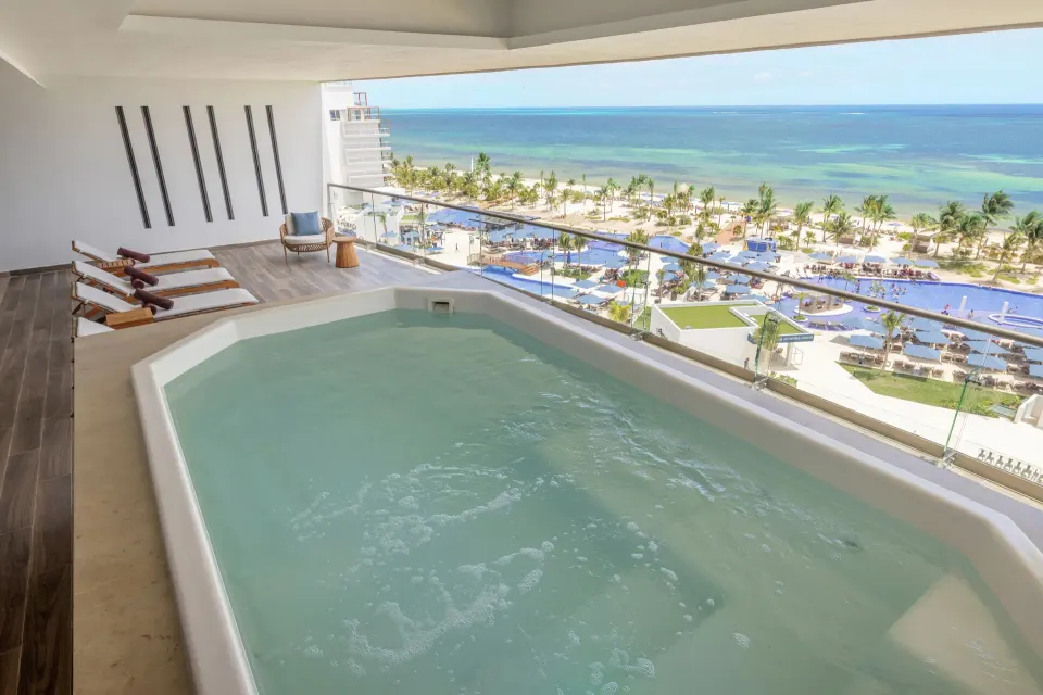 Suite plunge pool with beach and resort pools beyond at Royalton Splash Riviera Cancun.