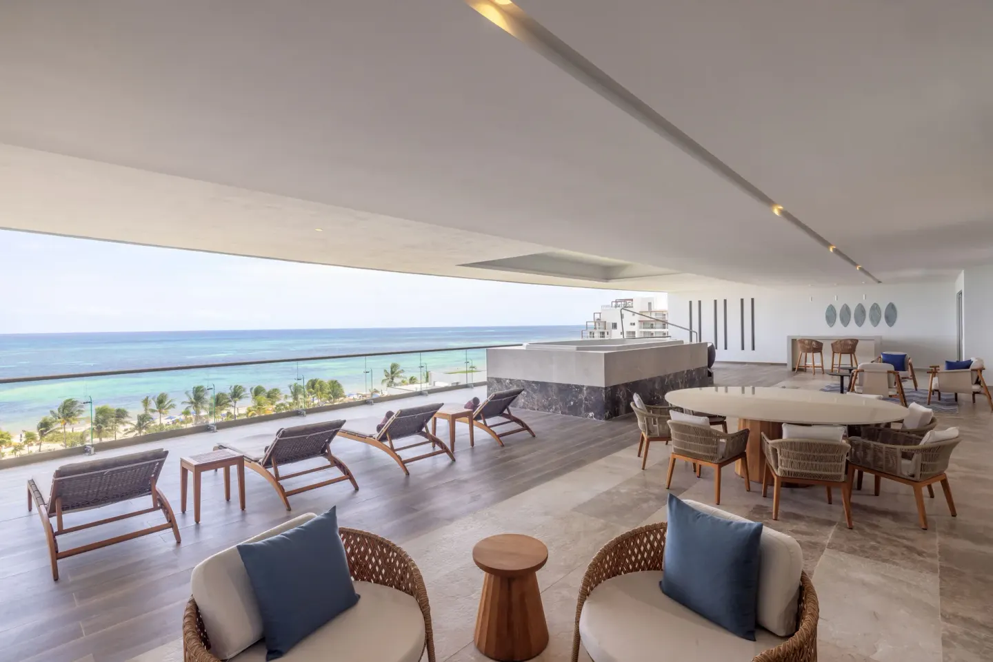 Oceanfront suite terrace with loungers and dining at Royalton Splash Riviera Cancun.