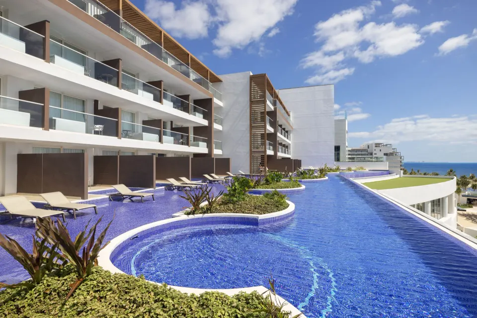 Swim-out pool area beside guest room balconies at Royalton Splash Riviera Cancun.