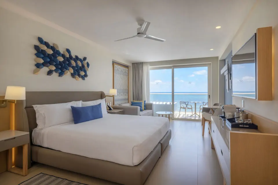 King bed suite with ocean-view balcony at Royalton Splash Riviera Cancun.