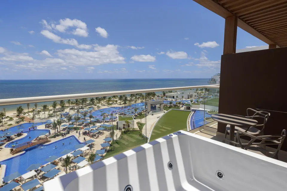 Terrace Jacuzzi with ocean and pool views at Royalton Splash Riviera Cancun.