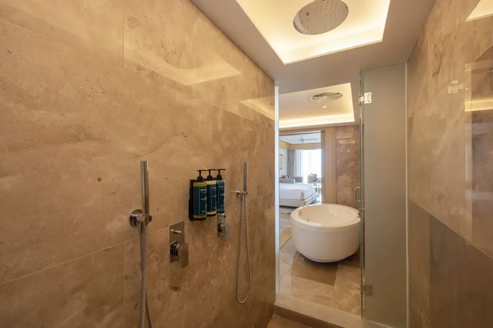 Marble shower and freestanding tub in a Luxury Junior Suite Swim Out Diamond Club at Royalton Splash Riviera Cancun.