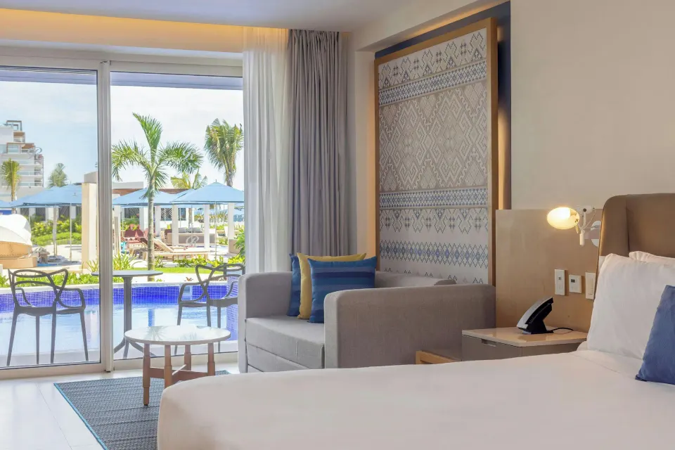 Luxury Junior Suite Swim Out with king bed and terrace at Royalton Splash Riviera Cancun.