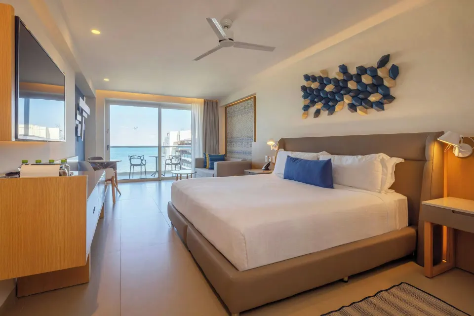 Luxury Junior Suite Swim Out king bed room with balcony at Royalton Splash Riviera Cancun.