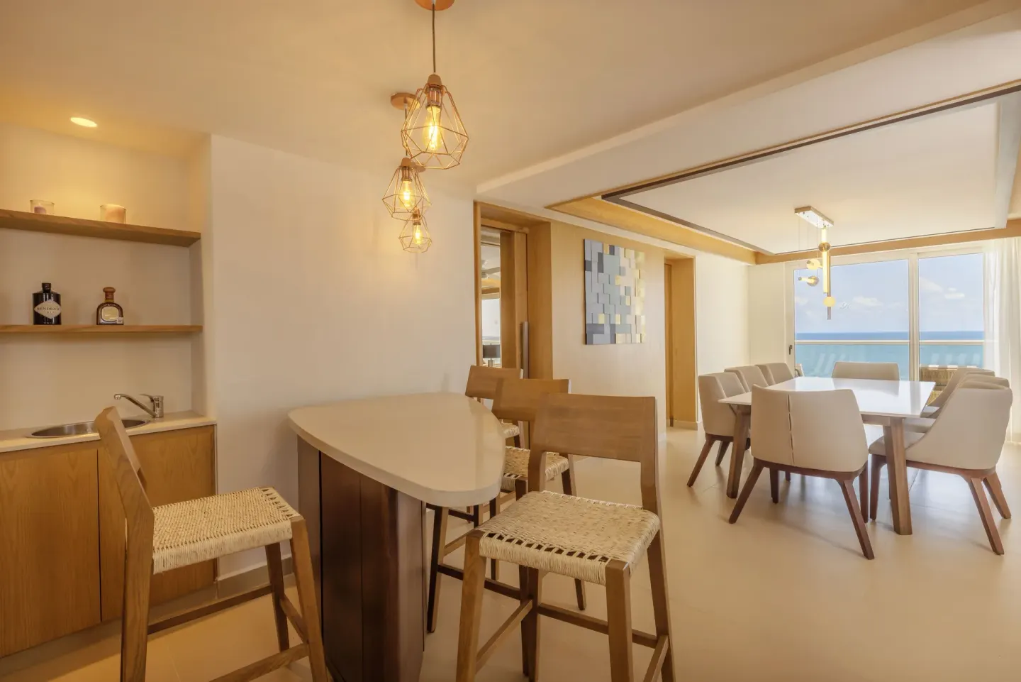 Dining area and bar counter with ocean view at Royalton Splash Riviera Cancun.