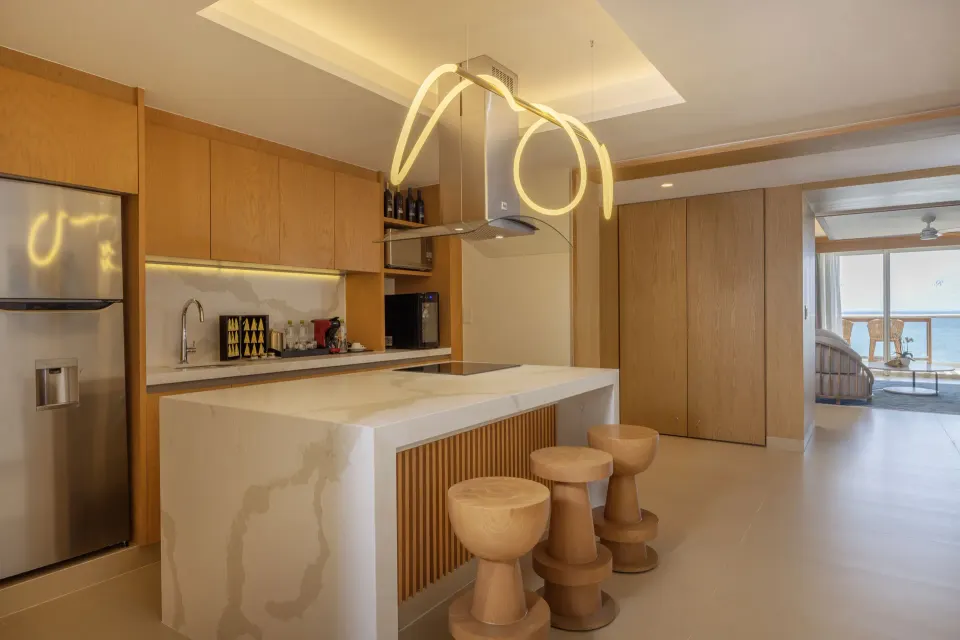 Suite kitchen with island and ocean view beyond at Royalton Splash Riviera Cancun.
