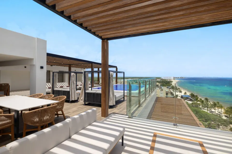 Covered terrace seating with beach and ocean views at Royalton Splash Riviera Cancun.