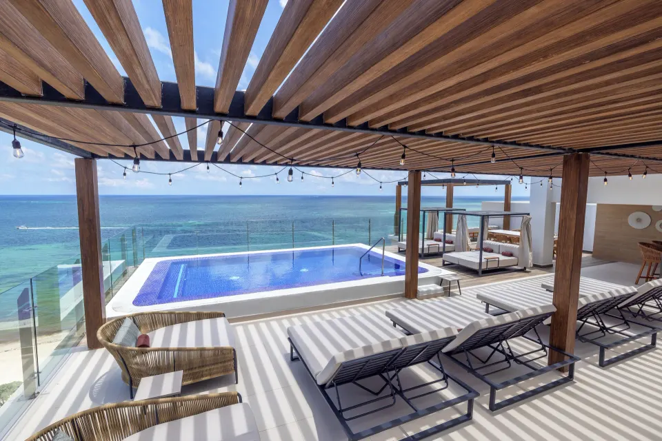 Oceanfront rooftop terrace with pool and loungers at Royalton Splash Riviera Cancun.