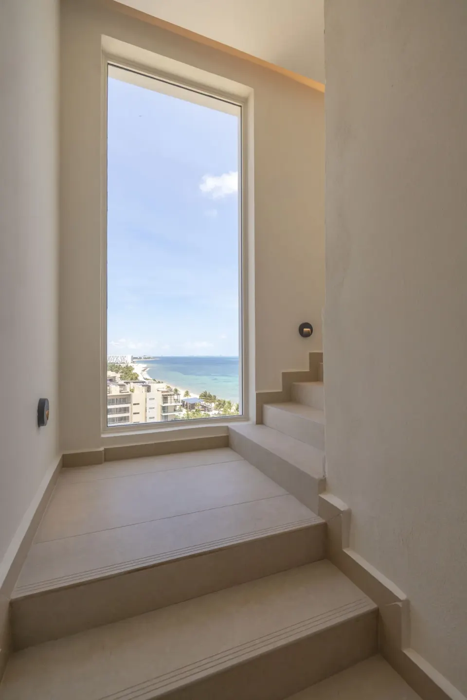 Stair landing window with ocean view in a suite at Royalton Splash Riviera Cancun.