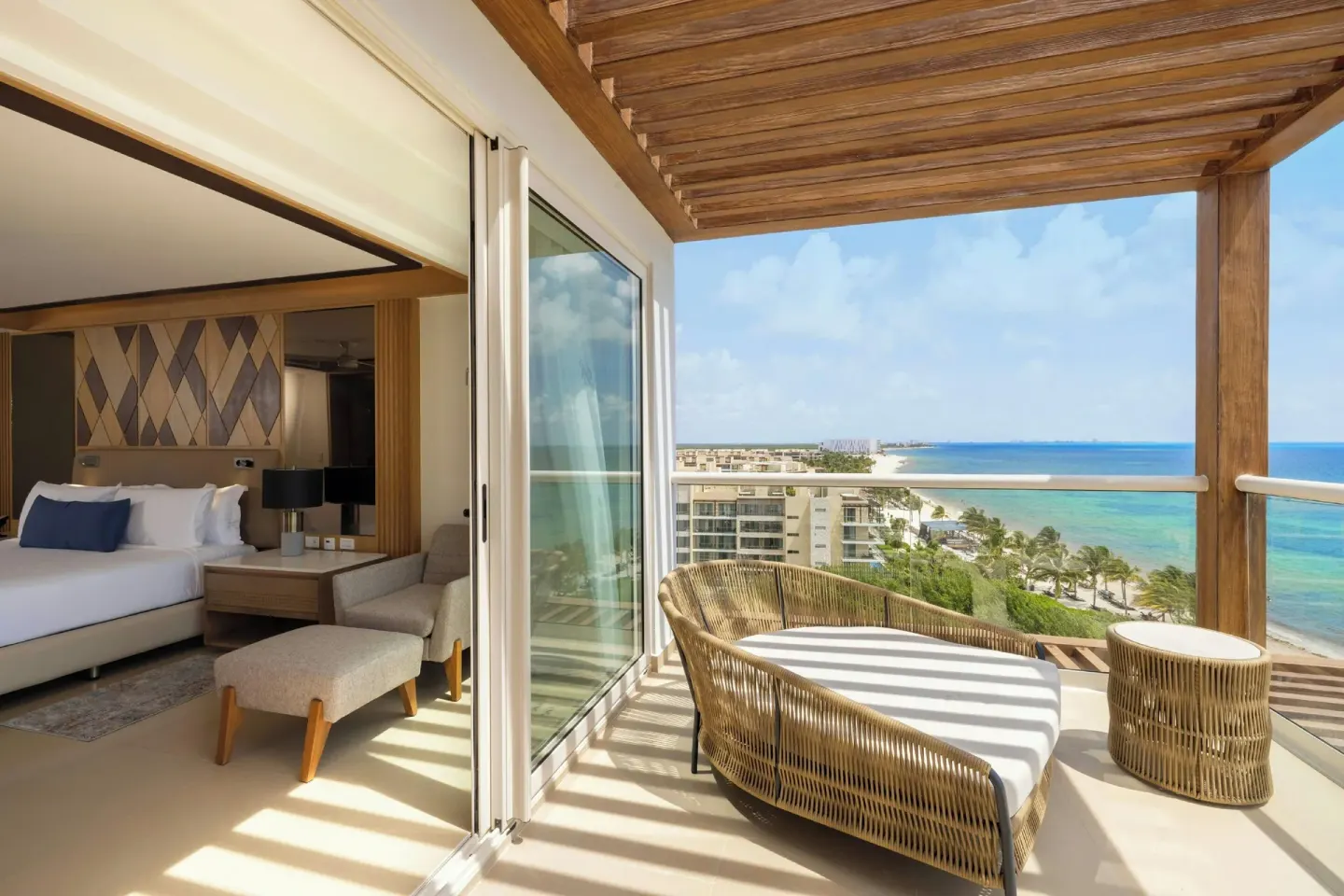 Oceanfront suite bedroom and balcony daybed at Royalton Splash Riviera Cancun.