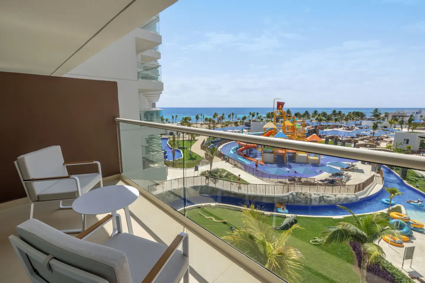 Furnished suite balcony with ocean and water park views at Royalton Splash Riviera Cancun.
