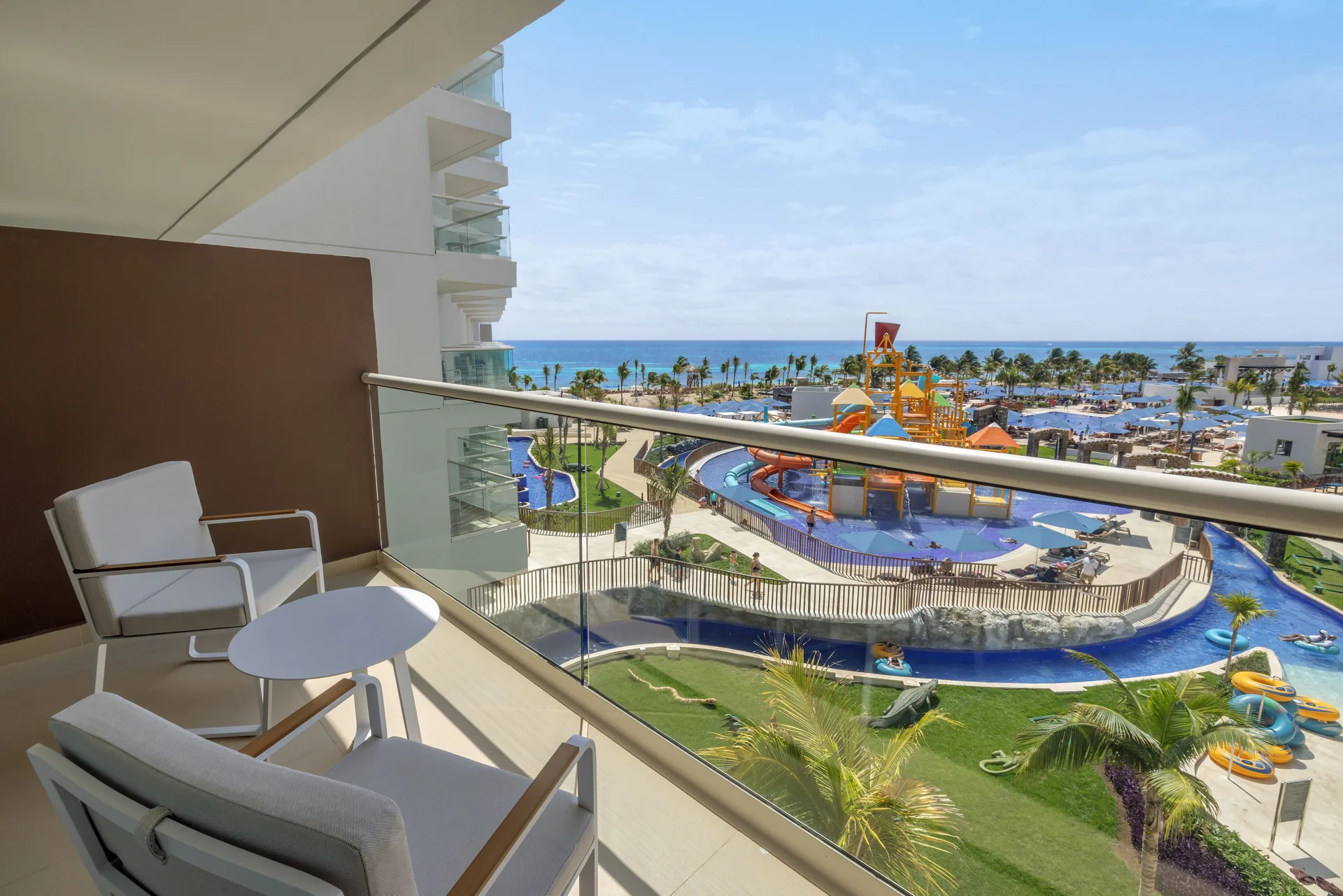 Furnished suite balcony with ocean and water park views at Royalton Splash Riviera Cancun.
