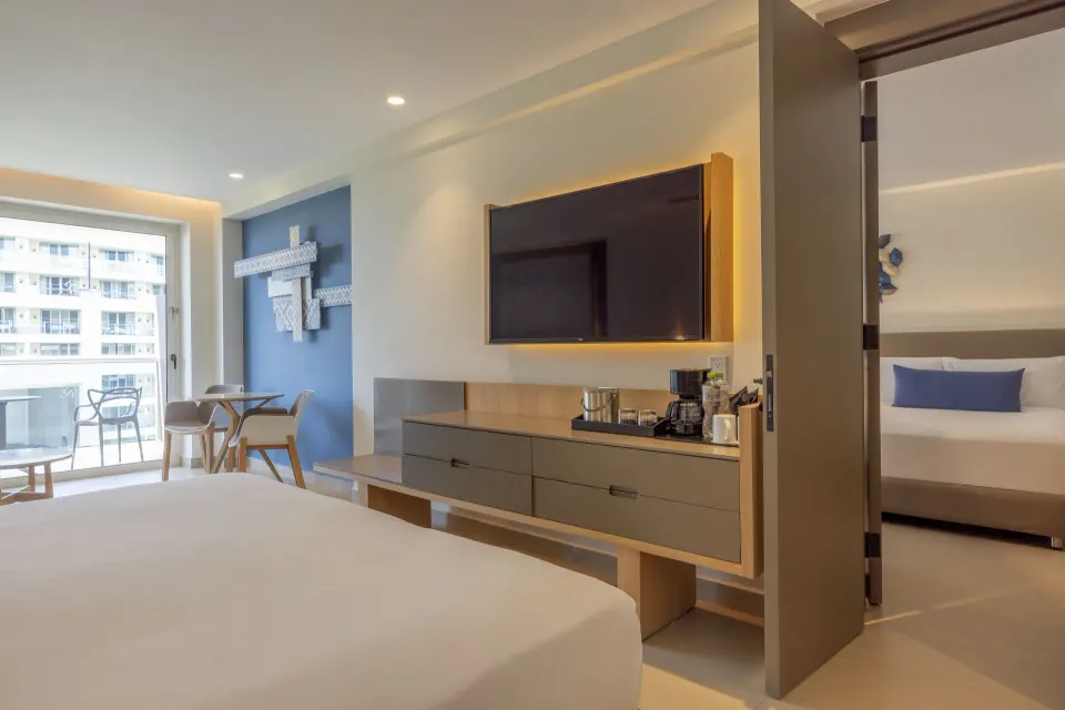 Two Bedroom Luxury Junior Suite with TV wall and adjoining bedroom at Royalton Splash Riviera Cancun.