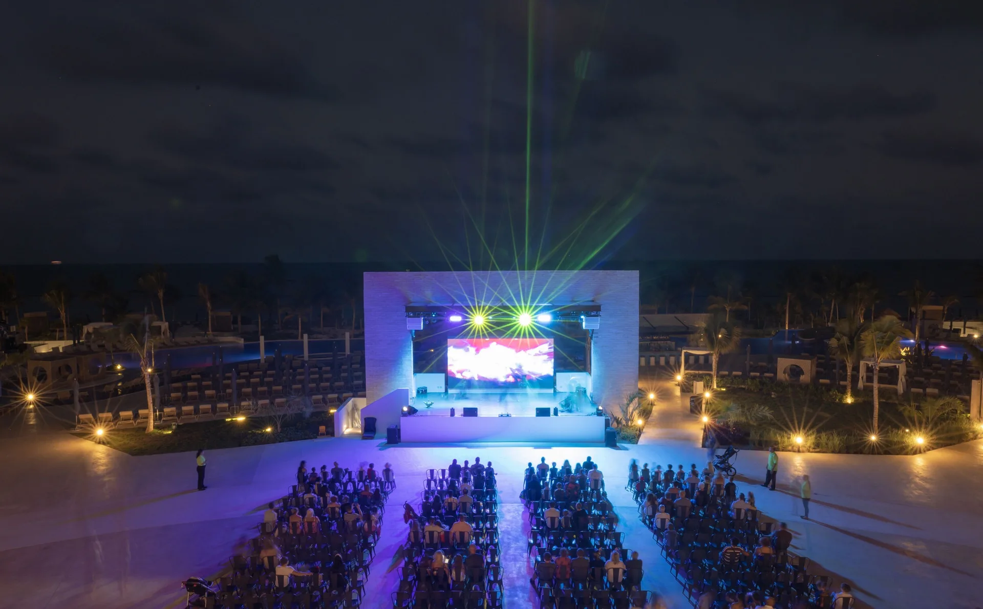 Nighttime outdoor stage show with laser lights at Royalton Splash Riviera Cancun.