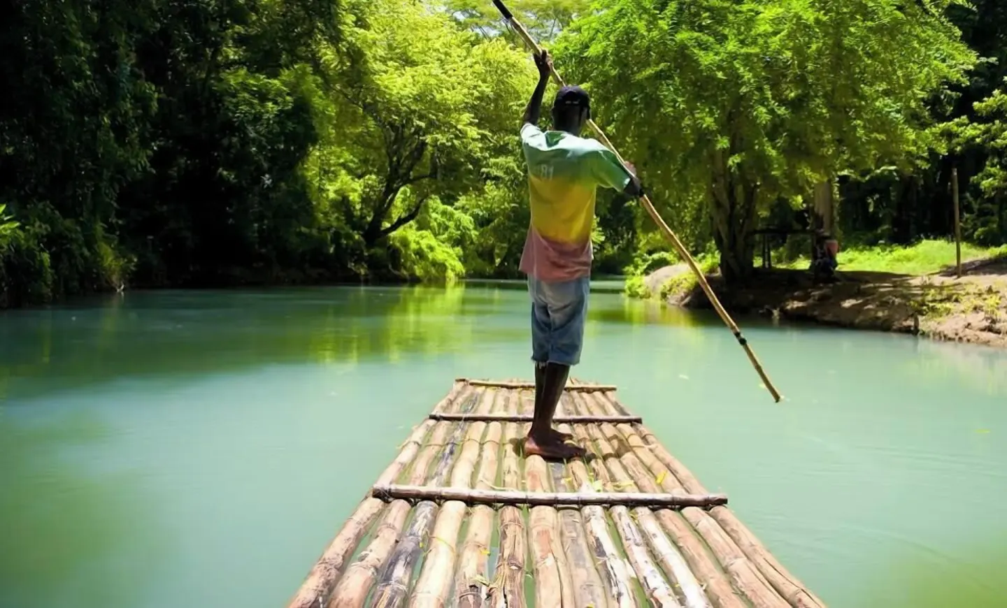 Bamboo raft gliding along a green river excursion near S Hotel Montego Bay.