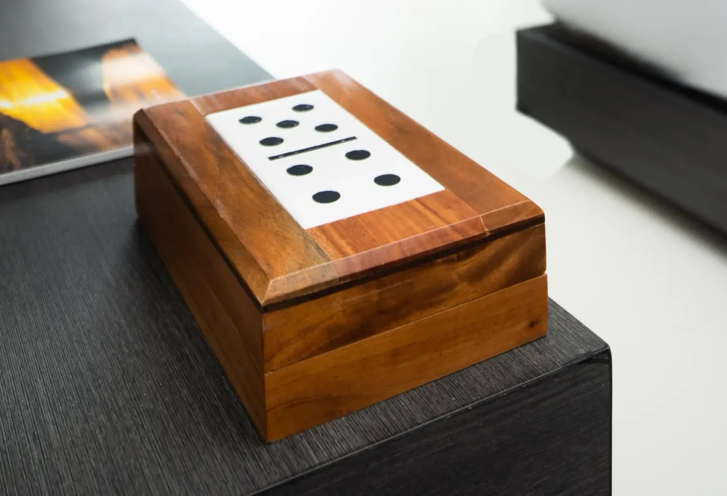 Wooden domino box on a dark tabletop in a guest room at S Hotel Montego Bay.