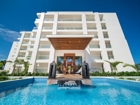 Front entrance, white balconies, and reflecting pool at S Hotel Montego Bay.