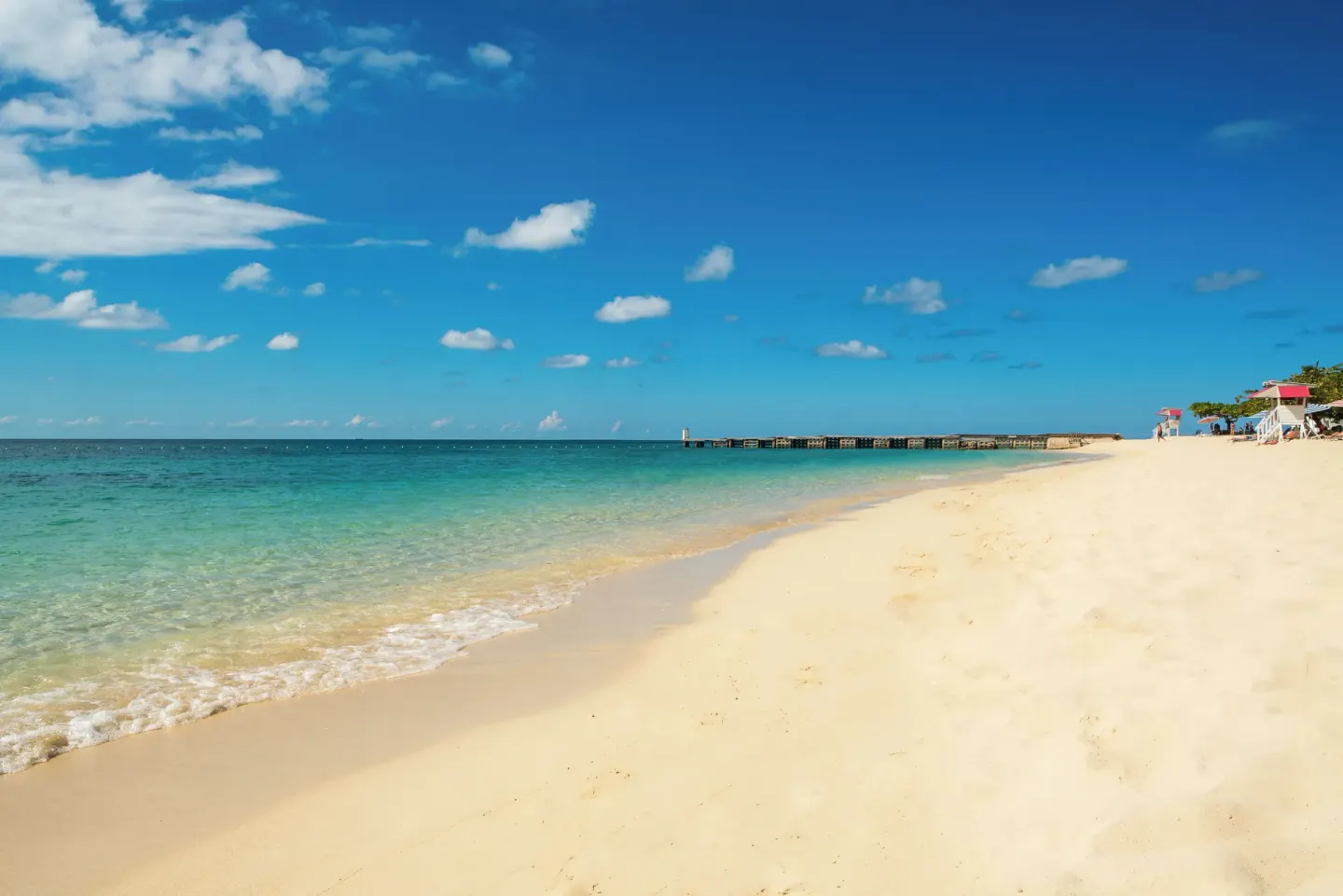 Quiet sandy beach and turquoise water at S Hotel Montego Bay.