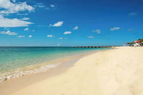 Quiet sandy beach and turquoise water at S Hotel Montego Bay.