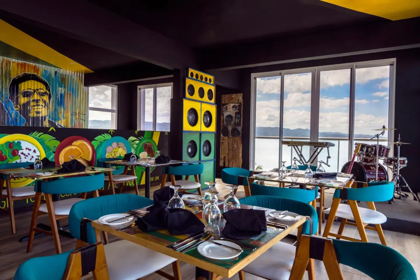 Colorful music-themed restaurant with stage and ocean-facing windows at S Hotel Montego Bay.