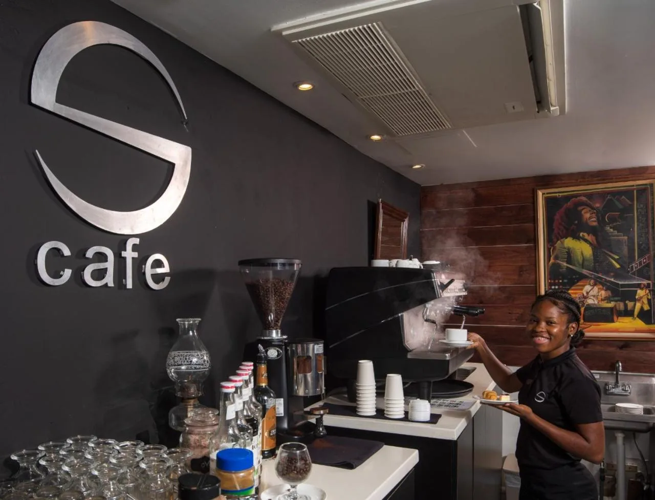 S Hotel Montego Bayé counter with barista and coffee equipment at S Hotel Montego Bay.