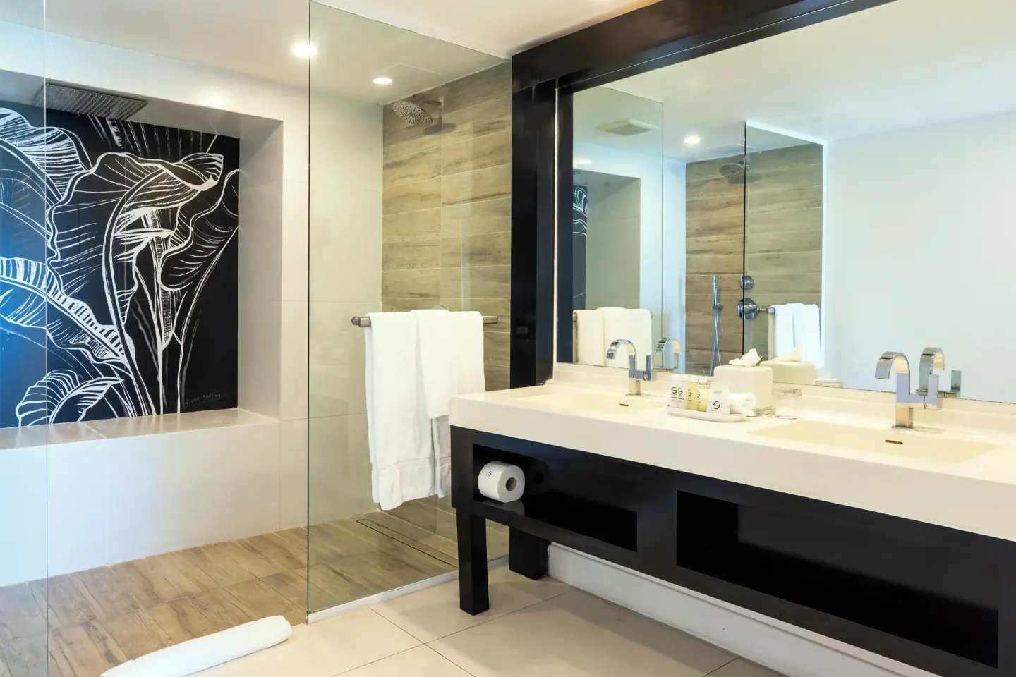 Deluxe Ocean View bathroom with double vanity and glass shower at S Hotel Montego Bay.