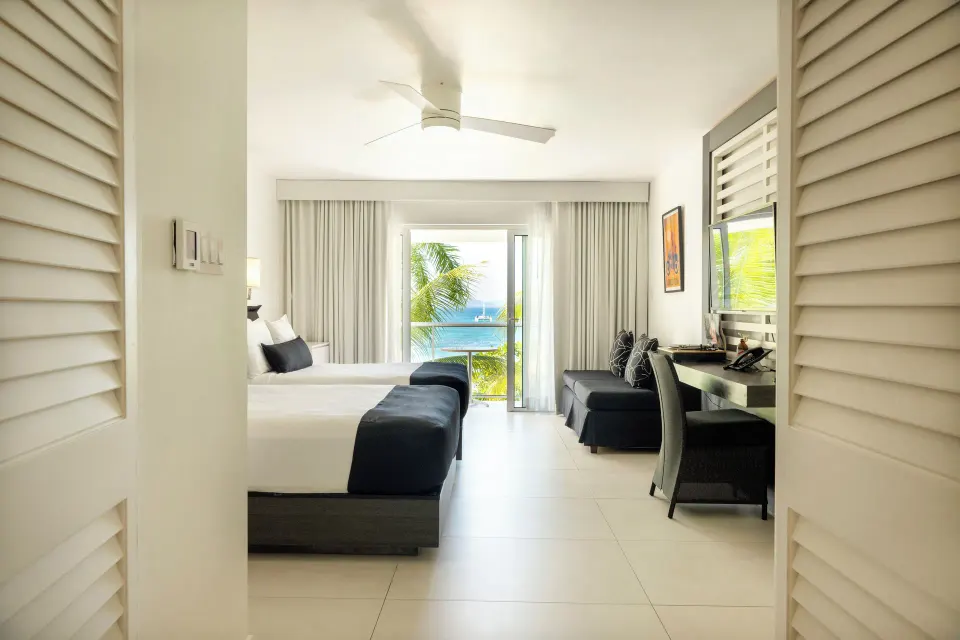Deluxe Ocean View room with two beds and balcony at S Hotel Montego Bay.